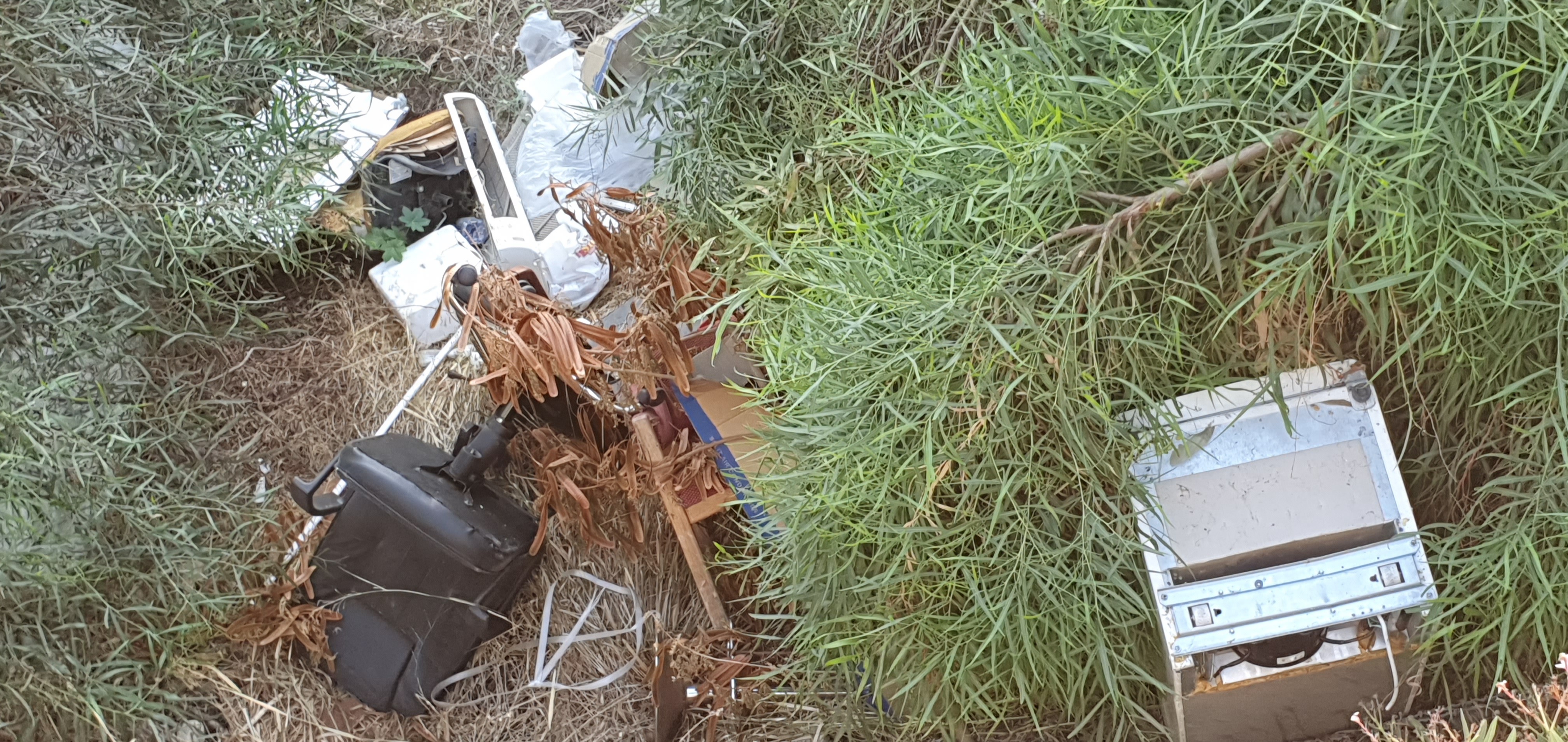 Large items dumped in the river - refrigerator, office chair, etc