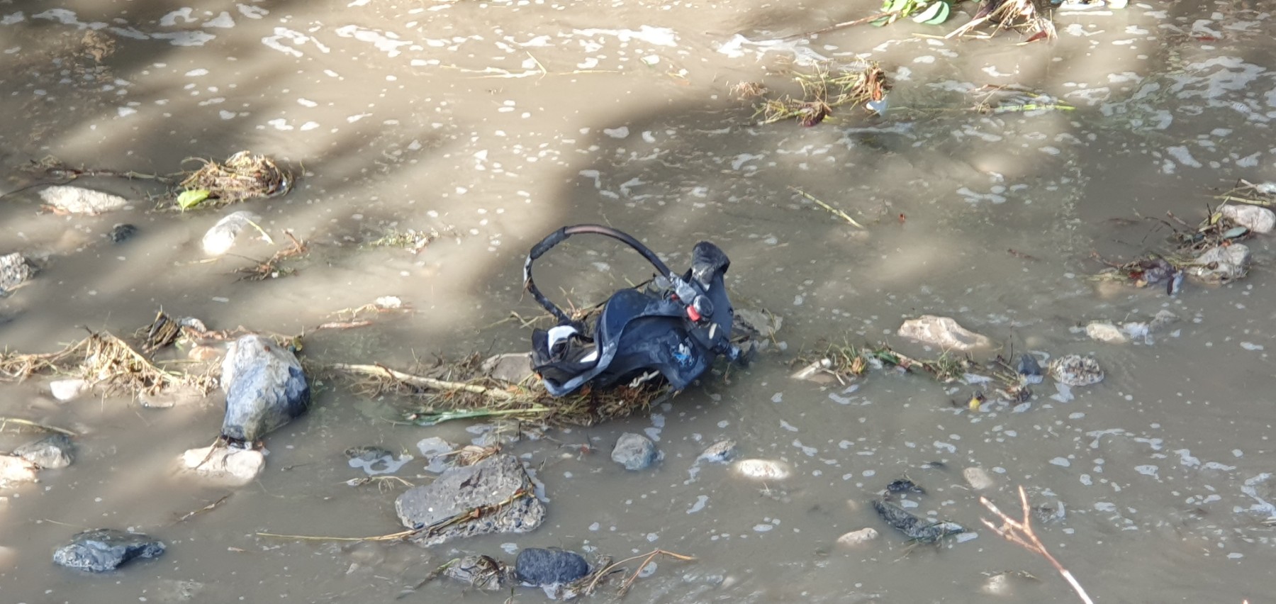 Children's car seat in the recently cleaned river